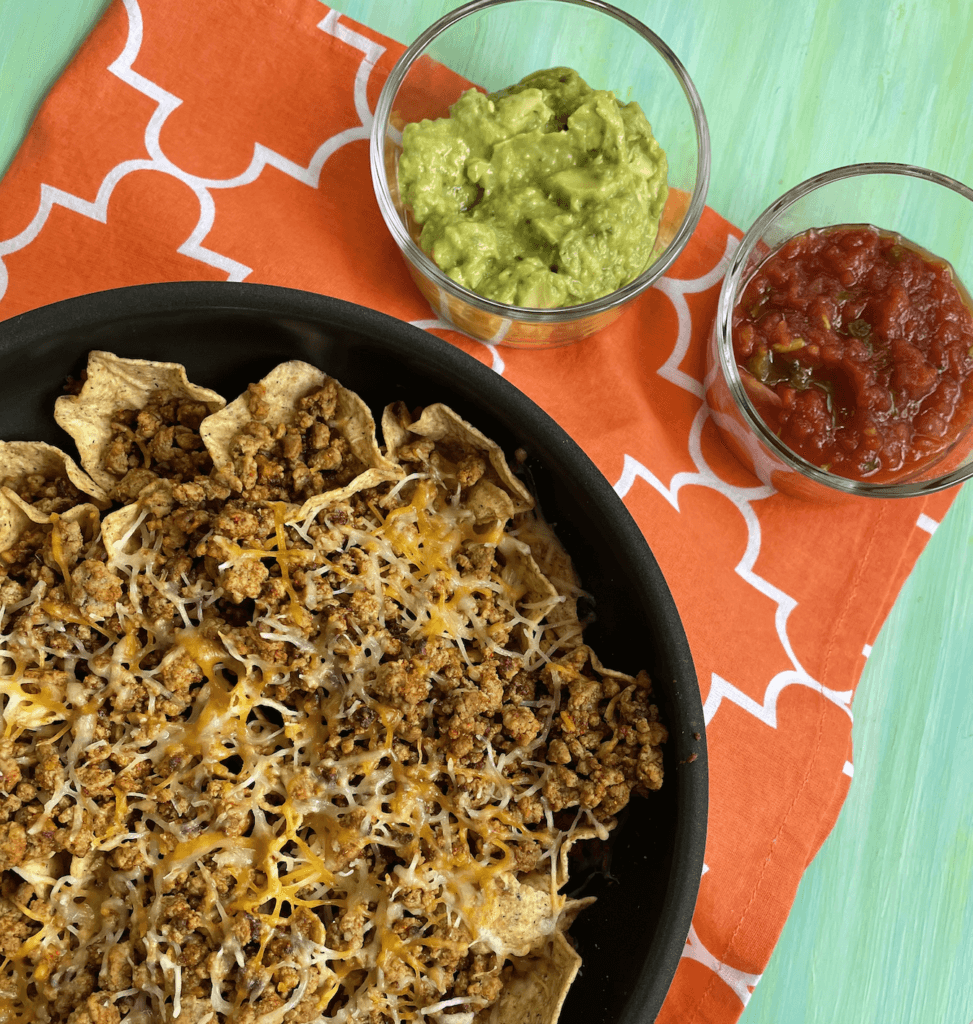Ground Beef skillet nachos make an easy weeknight meal ready in less than 30 minutes and packed with healthy foods like lean beef and veggies.