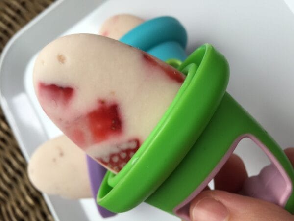 Frozen yogurt popsicles made with vanilla greek yogurt and fresh strawberries