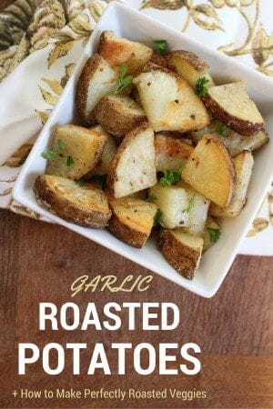 Whole garlic cloves and grated Parmesan cheese make these Garlic Roasted Potatoes a simple side dish the whole family will enjoy!