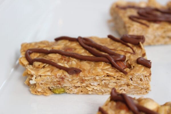 No Bake Nut Lover’s Bars are a combination of smooth peanut butter and chopped nuts, packed with healthy fats and protein, and topped with a drizzle of hazelnut spread.