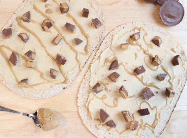 Peanut Butter Cup Pizza is the combination of two classic indulgences: peanut butter cups + pizza! Instead of a heavy crust, this sweet treat is made on Flatout Flatbread.