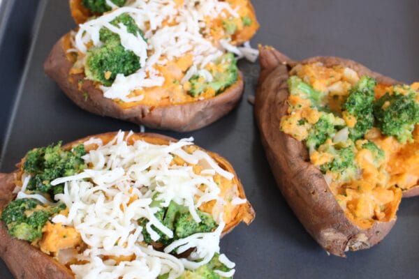 Stuffed sweet potatoes are filled and baked with veggies and cheese, making an easy weeknight meal or healthier side for Thanksgiving dinner.
