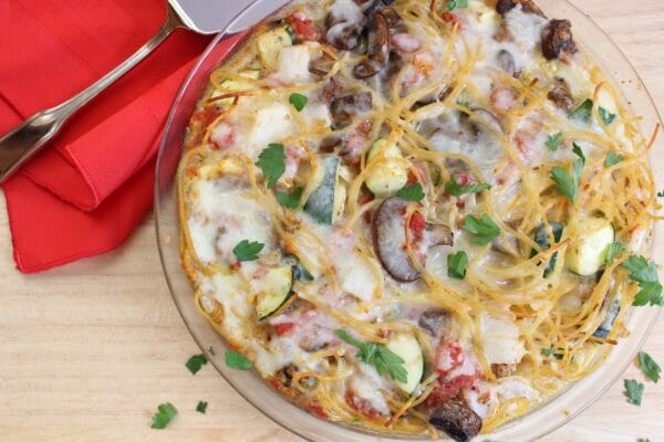 Spaghetti pie is a kid-friendly, calorie-friendly pasta dish baked right in pie dish. Be sure to toss the spaghetti with your family’s favorite pasta add-ins, such as fresh veggies, before baking.