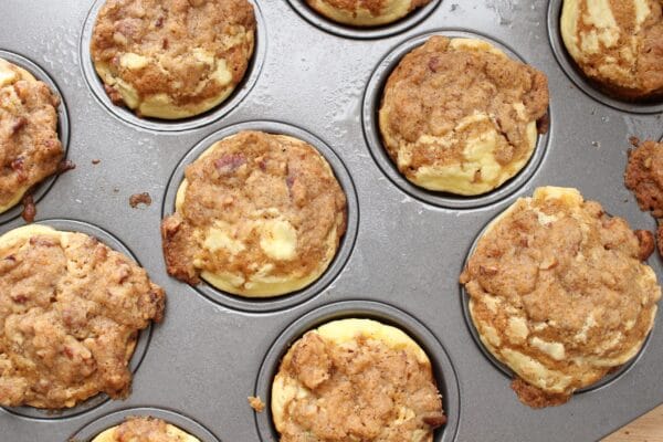 Carrot Pumpkin Cheesecake Muffins are moist, flavorful muffins filled with flavors of the fall and a few simple ingredients like shredded carrots, cream cheese, and pumpkin bread mix.