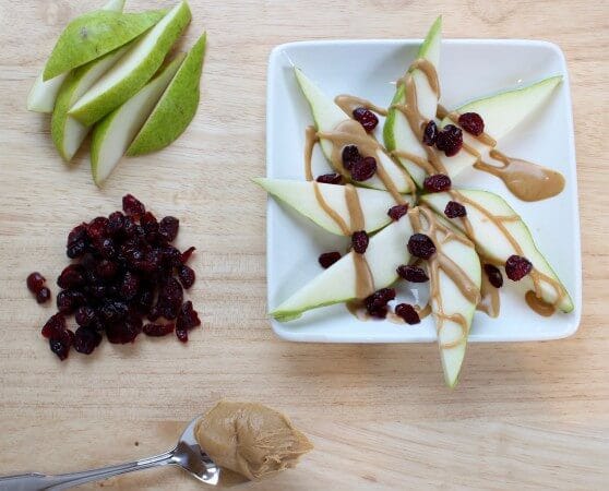 Easy to make pear nachos are a nutritious snack that will fuel any hungry tummy. Pear slices are simply topped with nut butter and dried cranberries.