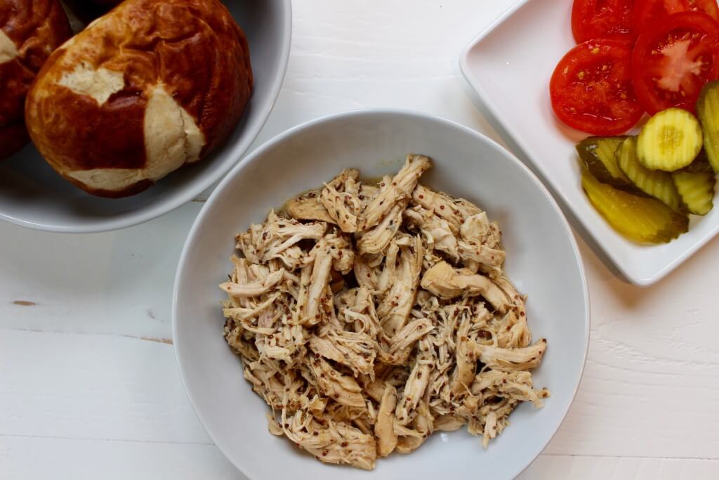 Sweet and tangy slow cooker honey mustard chicken combines simple ingredients for one tasty chicken dish perfect for sandwiches and wraps.