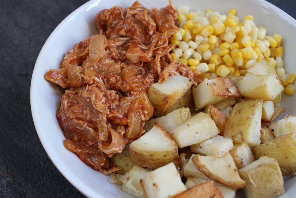 BBQ Chicken Bowls with slow cooked BBQ chicken, onions, roasted potatoes and corn make a simple make-ahead meal that are easily reheated for any busy weeknight.