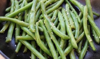 Fresh green beans are cooked with sesame seeds, soy sauce and chicken broth for a simple side dish with tons of flavor!