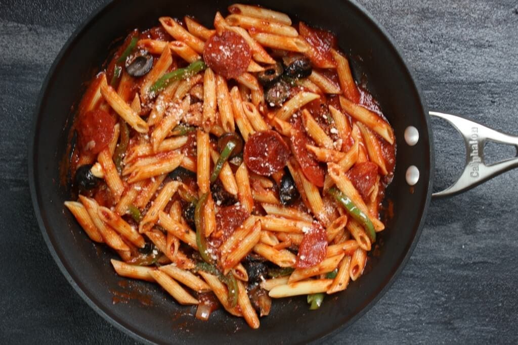 Skillet Pizza Pasta is a one pot meal that any pizza-loving family will enjoy! Ready in the amount of time it takes your pasta to cook, this easy weeknight meal is go-to dinner in our house!