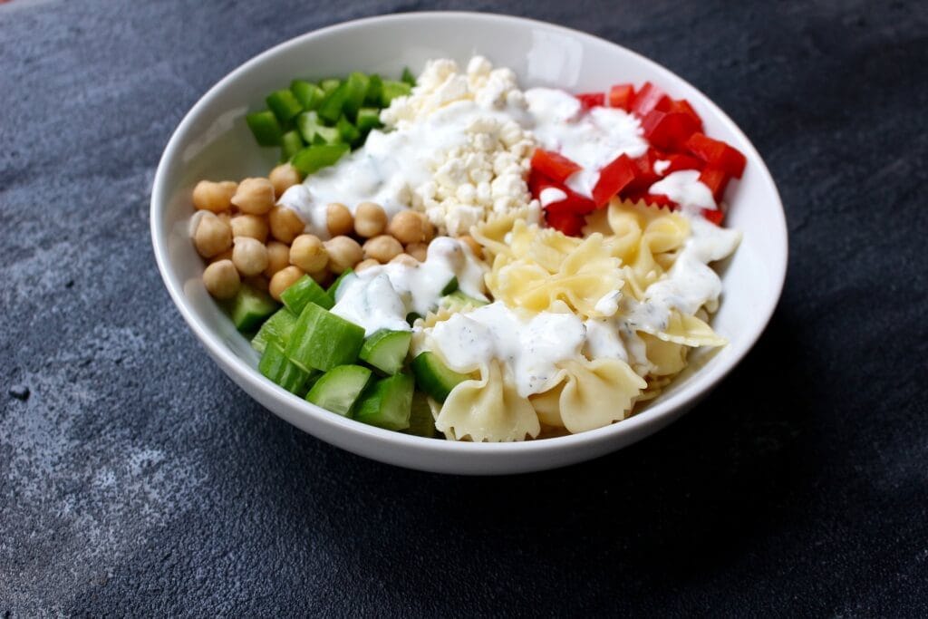 Chickpea Pasta Salad is a fresh and flavorful dish packed with protein, chopped veggies, and whole grain pasta.