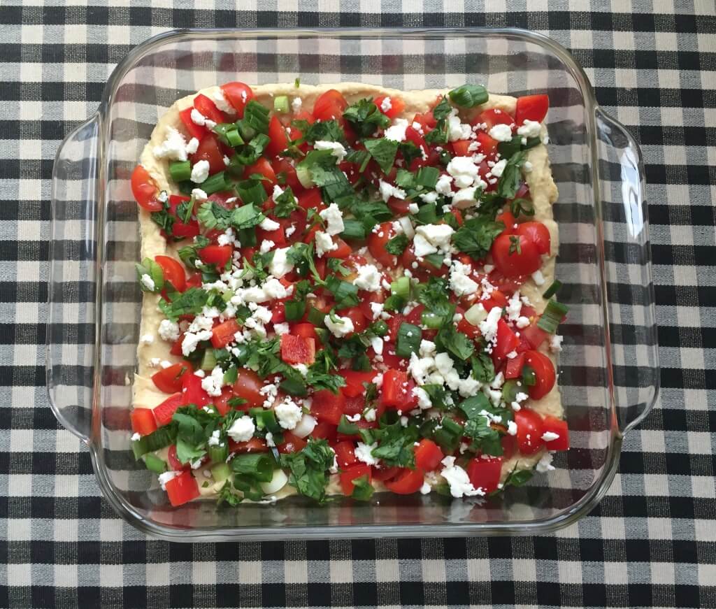 IMG_6070 - Mom to Mom Nutrition Mexican Layered Hummus Dip is a take on on the traditional party favorite but the base is protein-packed hummus. Topped with colorful, nutritious ingredients, this dip makes a fast snack or flavorful appetizer for any party.