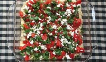 Mexican Layered Hummus Dip is a take on on the traditional party favorite but the base is protein-packed hummus. Topped with colorful, nutritious ingredients, this dip makes a fast snack or flavorful appetizer for any party.