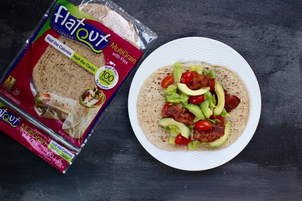 What could be better than a simple bacon, lettuce, tomato, and avocado wrap [BLTA wrap]?! Layered in a Flatout Flatbread this sandwich makes for the easiest lunch!