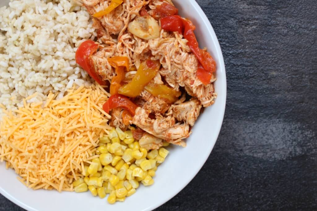 Slow cooker chicken enchilada bowls are the easy AND healthy way to make enchiladas. Without all the rolling that comes with traditional Mexican-inspired dish!