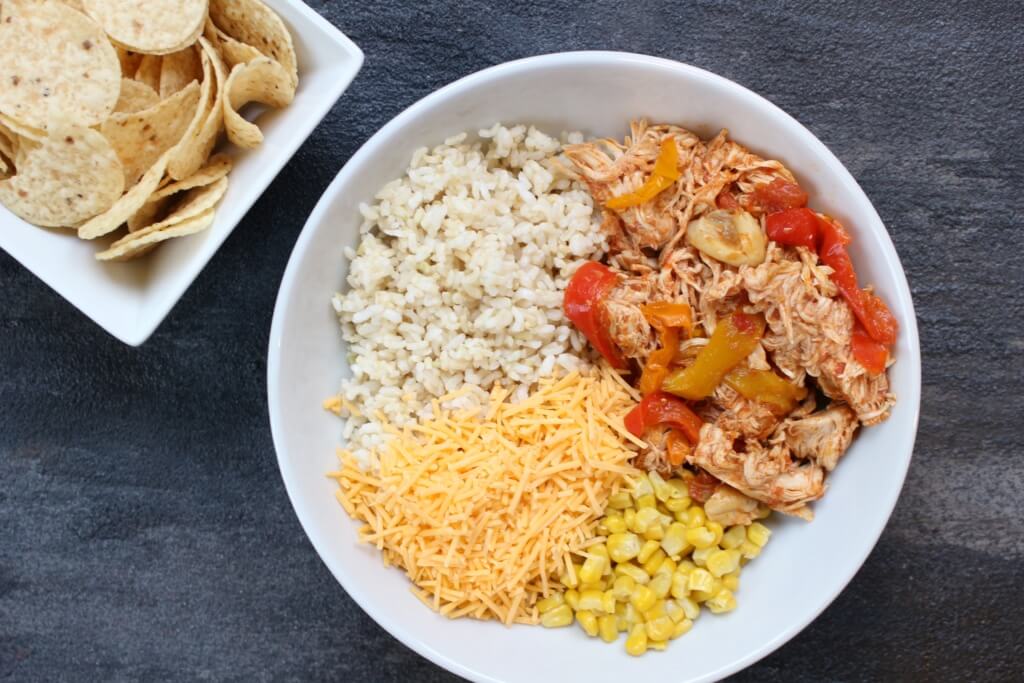 Slow cooker chicken enchilada bowls are the easy AND healthy way to make enchiladas. Without all the rolling that comes with traditional Mexican-inspired dish!