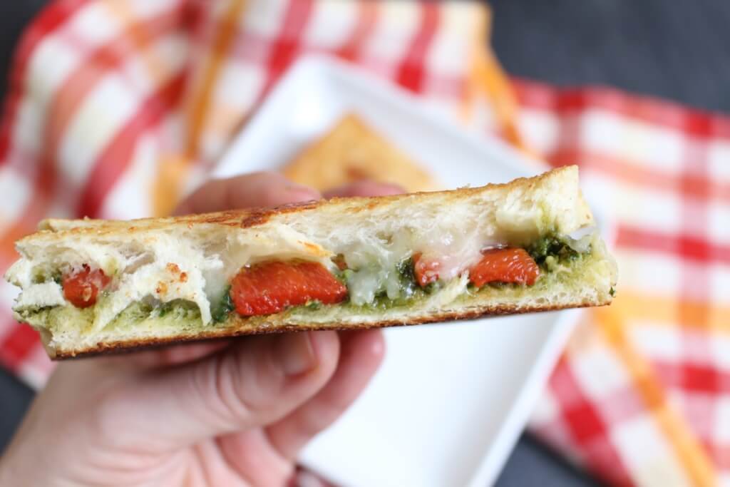 A simple grilled cheese sandwich is packed with extra flavor from pesto and roasted red pepper inside, giving it a gourmet spin!