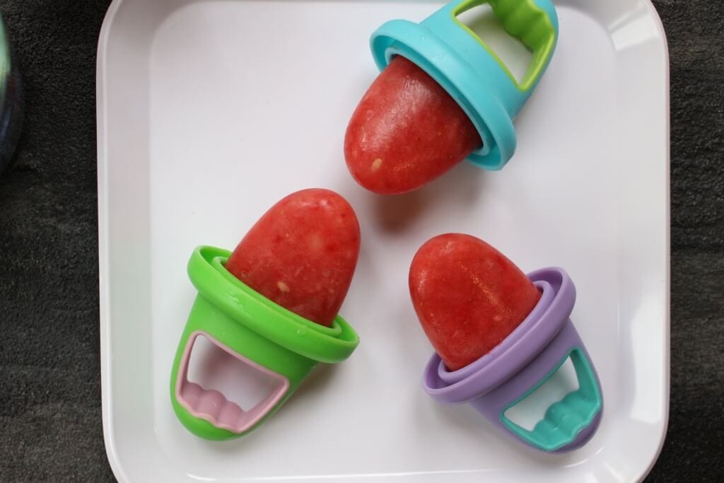 These watermelon popsicles are made with fresh and frozen fruit and zero added sugar, making the perfect healthy refreshing treat for any hot summer day! I don’t know what it is about watermelon and being pregnant, but some crazy watermelon craving comes over me when I’ve got a baby in my uterus. And since that’s been the case the past three years, you better believe I’ve consumed enough watermelon to feed a small army. Summer or not, my boys have always gravitated towards the sweet, water-filled fruit as well. So when the idea for these watermelon popsicles came to mind I knew that if I perfected my recipe, we’d be enjoying watermelon popsicles for years to come! I wasn’t sure if I needed to do a formal post for these watermelon popsicles as I already shared the how-to for them on Instagram and in my recent 10 Homemade Popsicles for Summer blog post. But since I’m practically dreaming and bathing in watermelon right now [c/o my 36th week of pregnancy], I figured why not talk about them some more! While we are happy campers just snacking on a bowl filled with sliced watermelon, there’s something to be said about using it in other recipes. Like all fruit, watermelon is naturally sweet and makes a great dessert or snack. Next time you want to serve up a kid-pleasing and healthy dish, think watermelon! Side note: Watermelon is 92% water--- making it a delicious hydrator. Chances are that’s why pregnant women and 