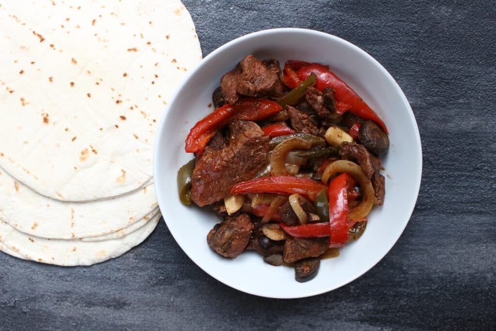 IMG_2971 - Mom to Mom Nutrition Tender steak and sweet bell peppers come together for one simple weeknight meal with these slow cooker steak fajitas!