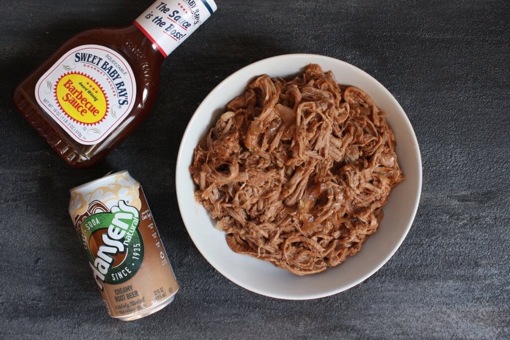 Pork tenderloin simmered in root beer and finished with BBQ sauce makes one simple, unique take on pulled pork sandwiches!