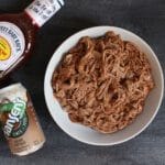 Pork tenderloin simmered in root beer and finished with BBQ sauce makes one simple, unique take on pulled pork sandwiches!