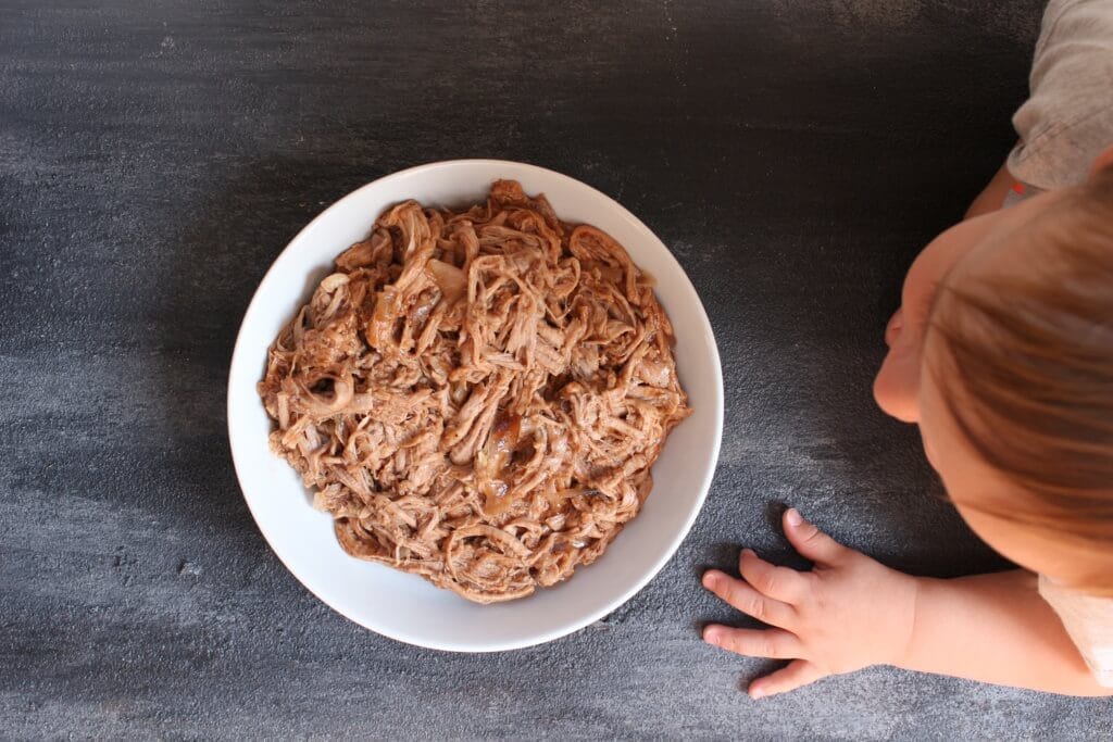 Pork tenderloin simmered in root beer and finished with BBQ sauce makes one simple, unique take on pulled pork sandwiches!