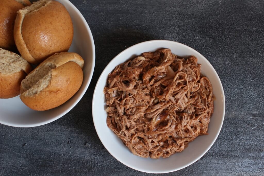 Pork tenderloin simmered in root beer and finished with BBQ sauce makes one simple, unique take on pulled pork sandwiches!