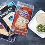 Chickpeas, quinoa, and whole grains make protein-packed hummus wraps the ideal lunch for those looking to get adequate amounts of plant protein at mealtime.