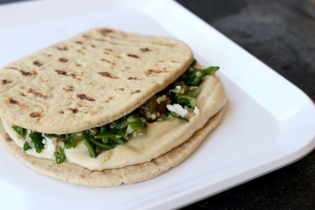 Chickpeas, quinoa, and whole grains make protein-packed hummus wraps the ideal lunch for those looking to get adequate amounts of plant protein at mealtime.