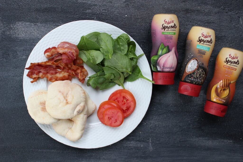 BLT Pita Pockets pack a punch of flavor for a quick and easy classic bacon, lettuce, and tomato sandwich with a simple hummus spread. Great for a quick school or work lunch!