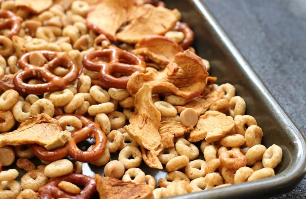 Combine the flavors of fall with this simple, crunchy apple peanut butter Cheerios snack mix. Made with Honey Nut Cheerios, dried apple chips, and peanut butter chips!