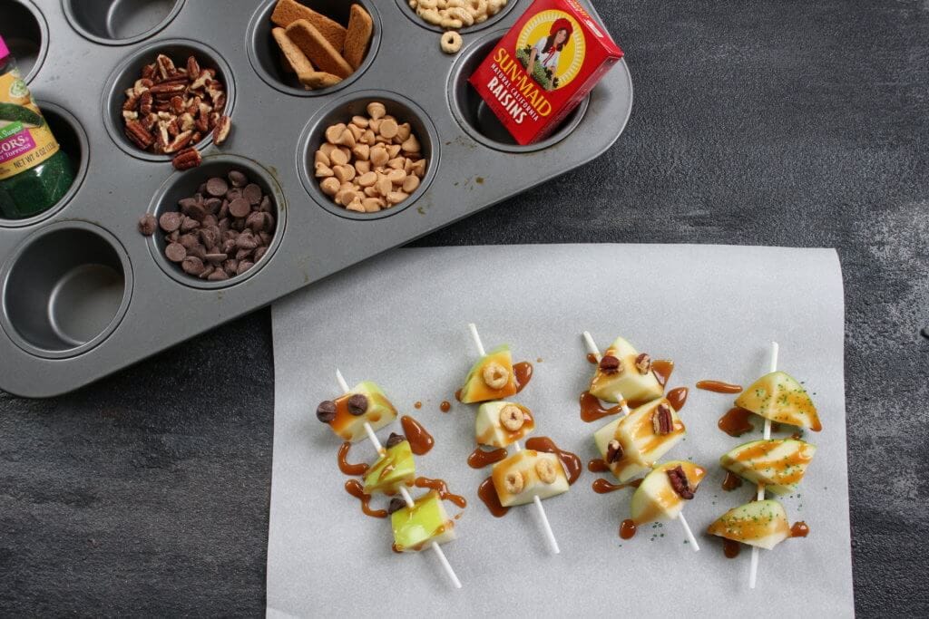 Caramel apple pops are an easy and delicious way to eat a traditional caramel apple. Get the kids involved in topping their own with dried cereal, chocolate chips, or extra caramel sauce!