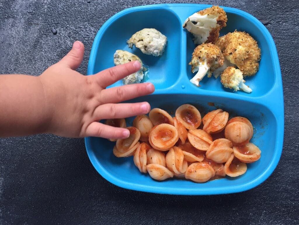 Baked parmesan cauliflower bites are breaded with a mixture of parmesan cheese and Italian seasoning, and served with marinara sauce for a perfect side dish or snack!