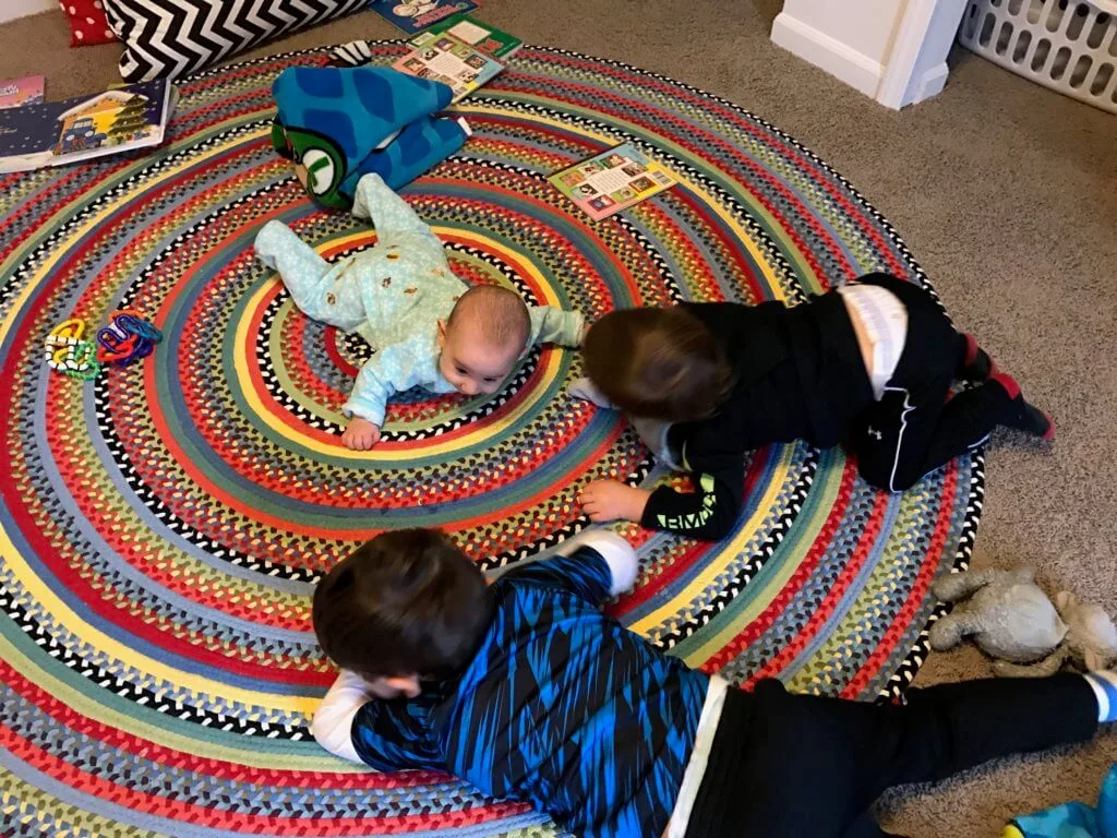 The whole crew doing tummy time! Notice the extra dinosaur sticker decor on Lily's back side... what are brother's for?!