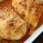 A simple chicken breast gets topped with creamy hummus for one weeknight meal that’s ready in no time! Sometimes I come up with a new meal idea and think to myself, “man, I still got it!” Just when I think my children have taken all my brain cells and zest for cooking with their hot dog and grilled cheese demands, I put two and two together like this hummus baked chicken and alas, mealtime is FUN again. Really though, whenever I serve chicken, steak, pork, etc. to the boys, I almost always serve it with hummus. Why? Because they dip almost anything in hummus. And I’m therefore almost guaranteed they’ll take a bit or two of the meat. So when my creative side decided it was time to TOP the chicken with hummus AND let the boys see what I was doing with their favorite spread [or dip], we were all pretty excited for the hummus baked chicken results! For this recipe I had Sabra Roasted Red Pepper hummus on hand so I decided to use that for the topping. Next time I think I’m going to try plain hummus + a tablespoon of dry ranch seasoning. Or maybe chipotle hummus + taco seasoning mix. Because there are so many flavors of hummus to choose from, the flavor combinations are endless!!! Needless to say, everyone enjoyed this simple meal that took less than 5 minutes to prep and dirtied one baking dish. My wheels are turning guys… what else besides chicken can I top with hummus and bake?!