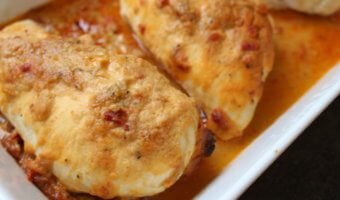 A simple chicken breast gets topped with creamy hummus for one weeknight meal that’s ready in no time! Sometimes I come up with a new meal idea and think to myself, “man, I still got it!” Just when I think my children have taken all my brain cells and zest for cooking with their hot dog and grilled cheese demands, I put two and two together like this hummus baked chicken and alas, mealtime is FUN again. Really though, whenever I serve chicken, steak, pork, etc. to the boys, I almost always serve it with hummus. Why? Because they dip almost anything in hummus. And I’m therefore almost guaranteed they’ll take a bit or two of the meat. So when my creative side decided it was time to TOP the chicken with hummus AND let the boys see what I was doing with their favorite spread [or dip], we were all pretty excited for the hummus baked chicken results! For this recipe I had Sabra Roasted Red Pepper hummus on hand so I decided to use that for the topping. Next time I think I’m going to try plain hummus + a tablespoon of dry ranch seasoning. Or maybe chipotle hummus + taco seasoning mix. Because there are so many flavors of hummus to choose from, the flavor combinations are endless!!! Needless to say, everyone enjoyed this simple meal that took less than 5 minutes to prep and dirtied one baking dish. My wheels are turning guys… what else besides chicken can I top with hummus and bake?!