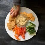 Hummus snack plates are perfect for a shareable lunch or snack. Just serve your favorite hummus alongside fresh dippers like pepper or cucumber strips and crackers.