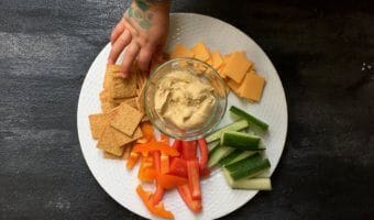 Hummus snack plates are perfect for a shareable lunch or snack. Just serve your favorite hummus alongside fresh dippers like pepper or cucumber strips and crackers.