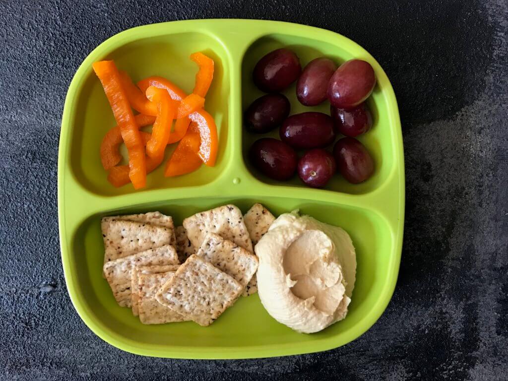 Hummus snack plates are perfect for a shareable lunch or snack. Just serve your favorite hummus alongside fresh dippers like pepper or cucumber strips and crackers. 