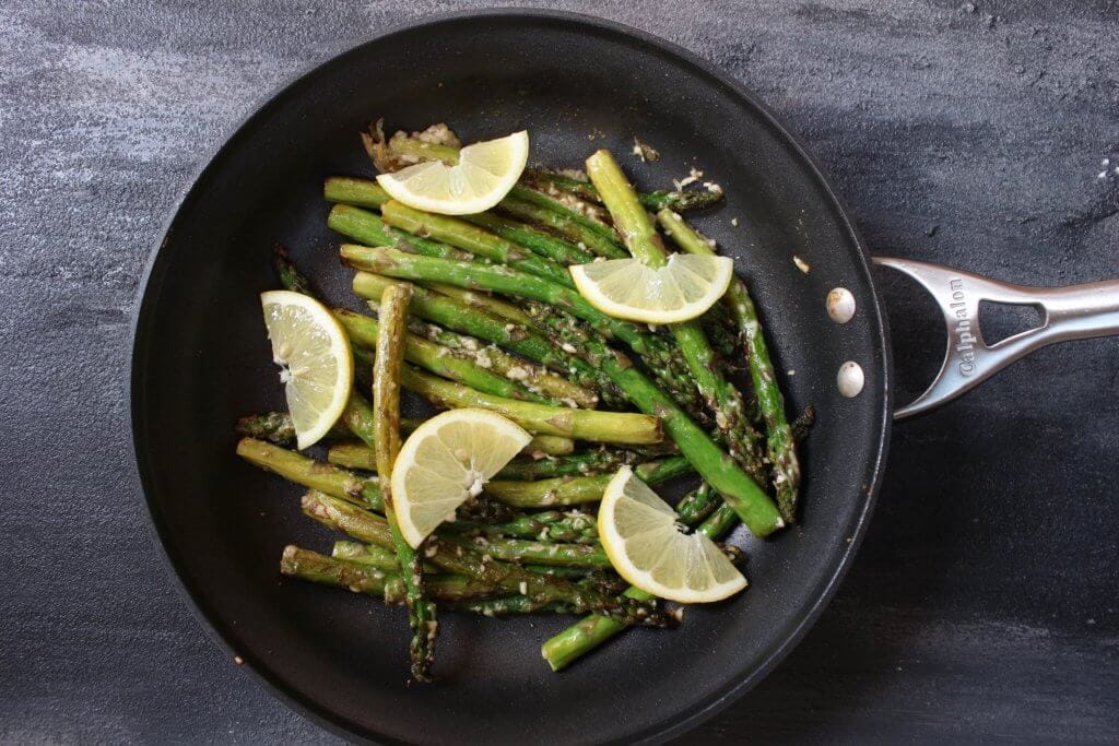IMG_2994 - Mom to Mom Nutrition Lemony asparagus with garlic and parmesan is a quick and easy side dish, served with fresh lemon slices for a bright, spring recipe!