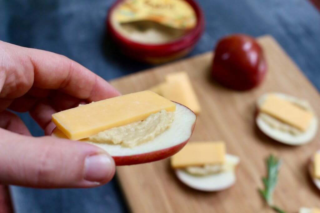 IMG_3517 - Mom to Mom Nutrition Apple hummus stackers make one protein-packed snack, appetizer, or post-workout treat that’s ready in one simple step, with just 3-ingredients: apples, hummus, and cheddar cheese!