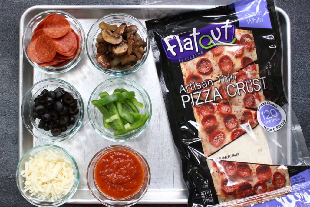 Pizza for dinner, again? Yes! Change-up your weekly pizza routine with a build your own pizza bar for dinner! The best part? The kids can make their own.