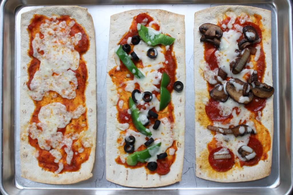 Pizza for dinner, again? Yes! Change-up your weekly pizza routine with a build your own pizza bar for dinner! The best part? The kids can make their own.