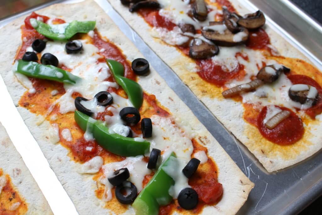 Pizza for dinner, again? Yes! Change-up your weekly pizza routine with a build your own pizza bar for dinner! The best part? The kids can make their own.