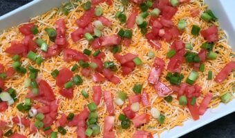 Taco-inspired Hummus Dip tastes exactly like eating a taco, but in hummus form! Made with Sabra taco hummus, this layered dip of all your favorite taco ingredients makes the perfect dip for any occasion.