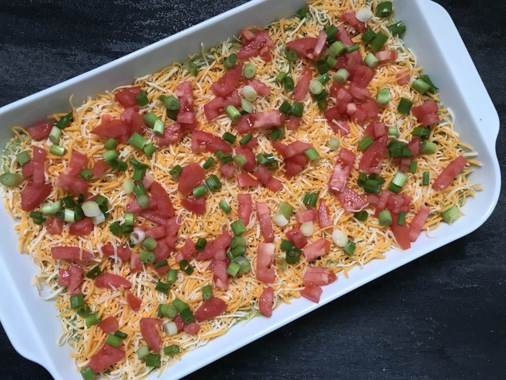 Taco-inspired Hummus Dip tastes exactly like eating a taco, but in hummus form! Made with Sabra taco hummus, this layered dip of all your favorite taco ingredients makes the perfect dip for any occasion. 