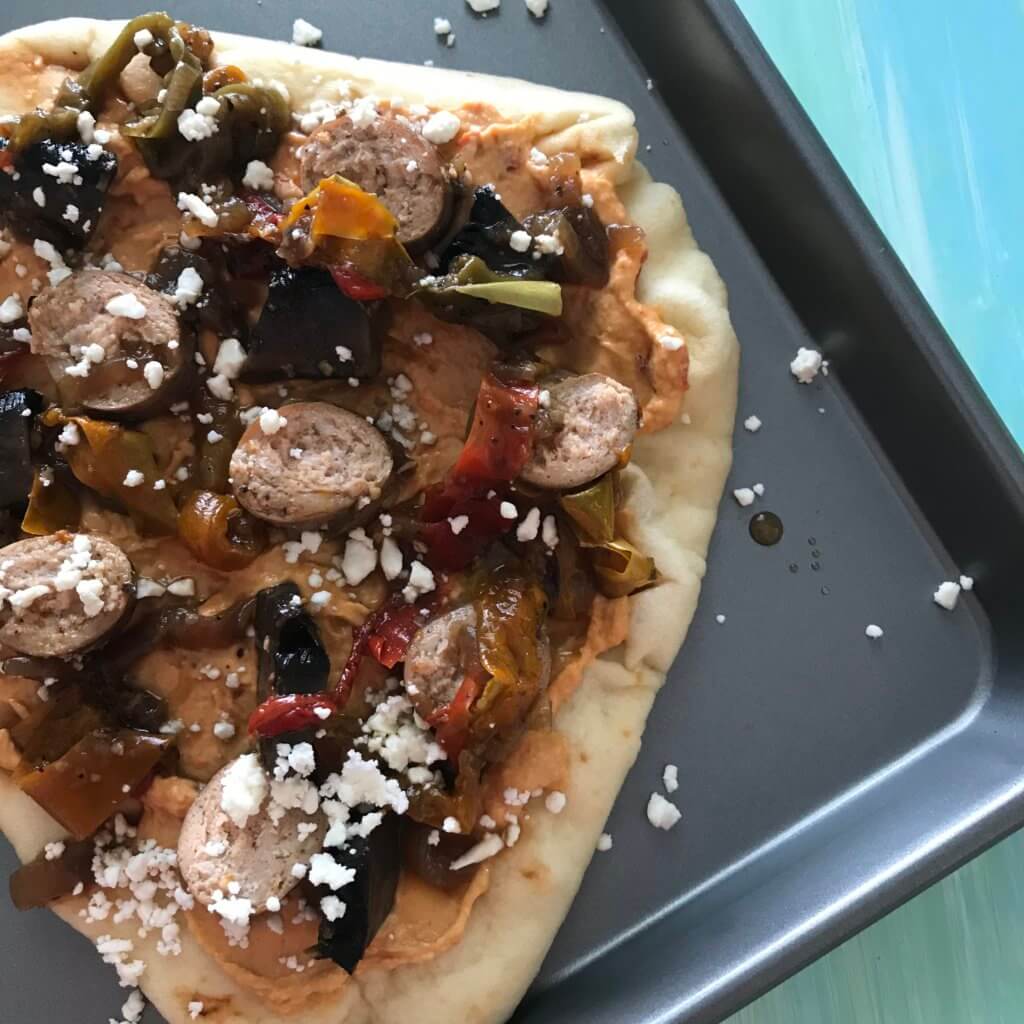 IMG_5916 - Mom to Mom Nutrition Sausage Pepper and Onion Flatbreads are as simple as they sound. Let your slow cooker do the work for the sausage, and the mixture of hummus and feta cheese serve as the base for these flatbreads.