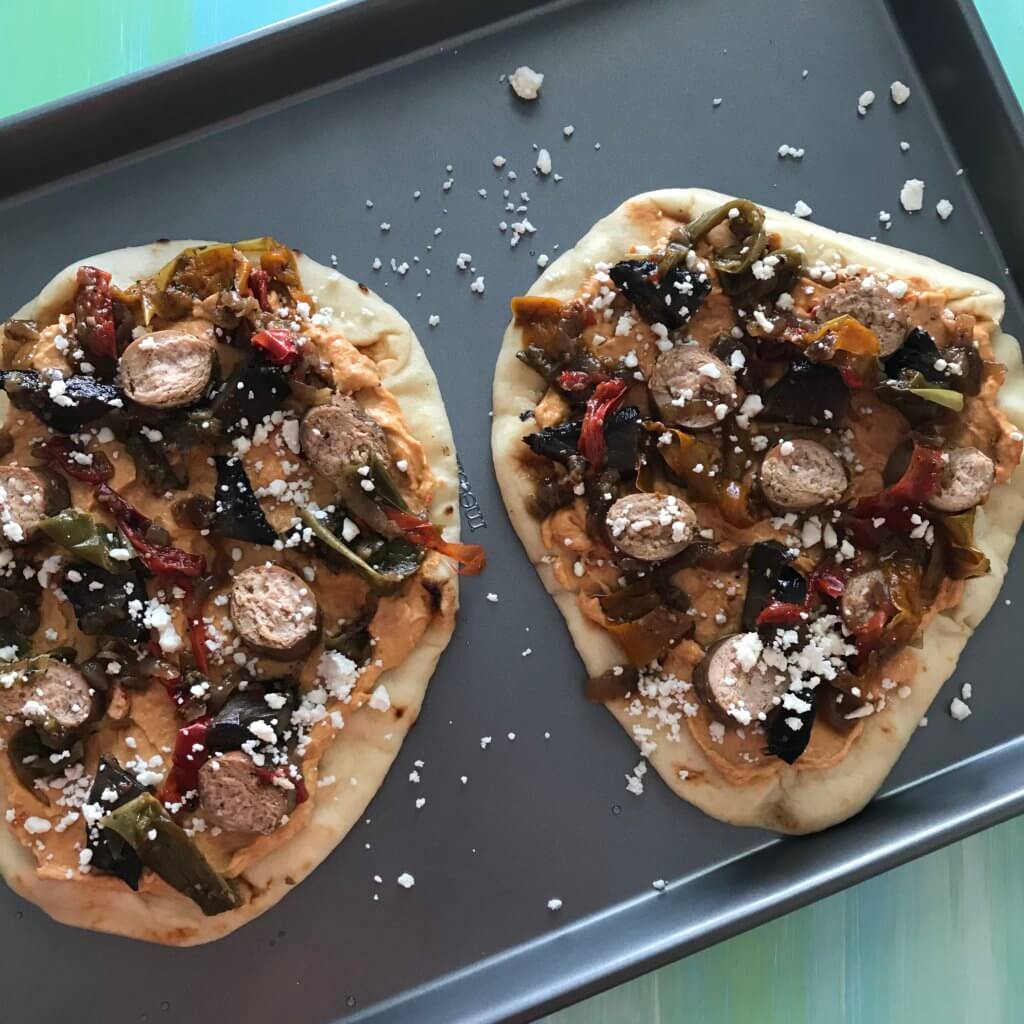 IMG_5917 - Mom to Mom Nutrition Sausage Pepper and Onion Flatbreads are as simple as they sound. Let your slow cooker do the work for the sausage, and the mixture of hummus and feta cheese serve as the base for these flatbreads.