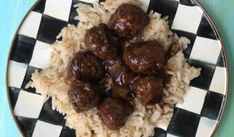 5 Ingredient Slow Cooker Meatballs are simple, saucy, and the ideal kid-friendly dinner. Once you have the meatballs rolled, just let your slow cooker do the work and enjoy in 4 hours! 