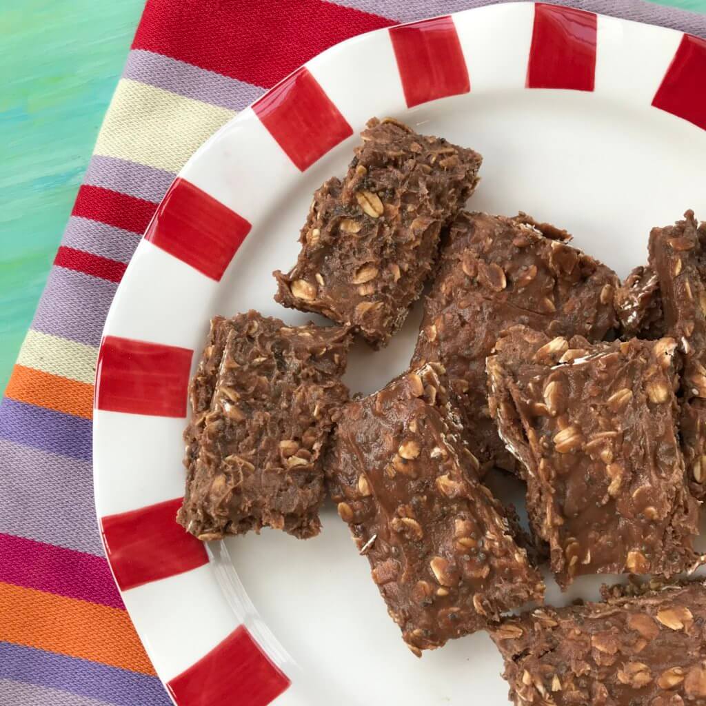 proetin-bars-7 - Mom to Mom Nutrition No-bake chocolate protein bars stacked on a white and red plate.