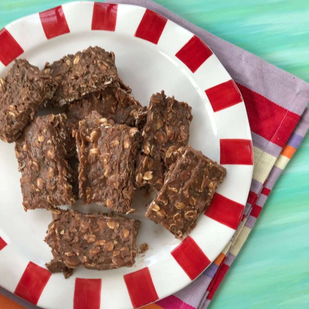 proetin-bars-8 - Mom to Mom Nutrition No-bake chocolate protein bars stacked on a white and red plate.